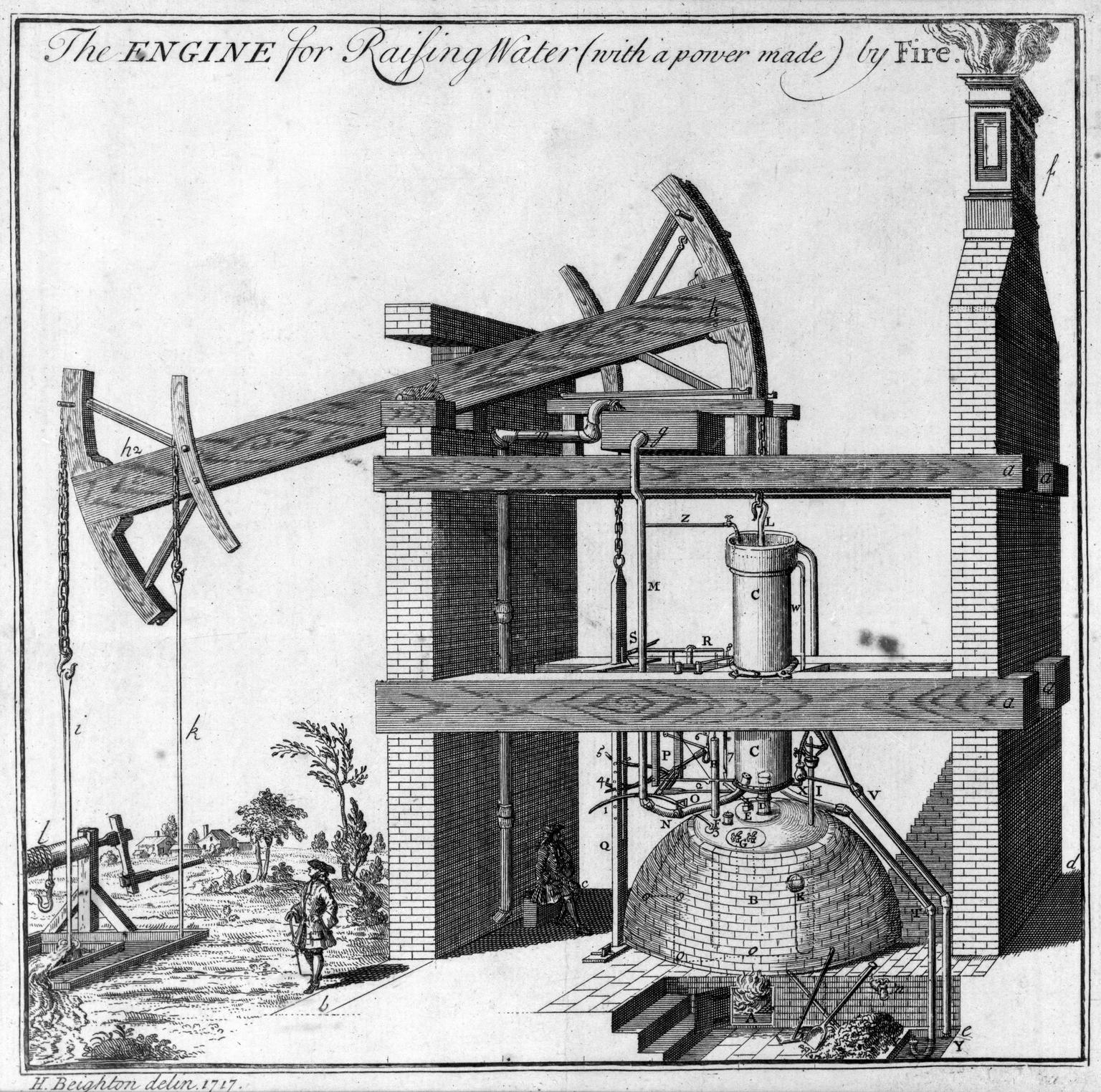 A 1717 copperplate engraving of Newcomen's atmospheric engine in a tall brick engine house. A massive timber beam rocks on the wall of the house; its left arm hangs chains down a mine shaft, its right arm lifts a piston in a cylinder that stands on a domed brick boiler with a fire beneath. A brick chimney rises at the right, smoking. A gentleman in a long coat stands in the foreground for scale, a village behind him.