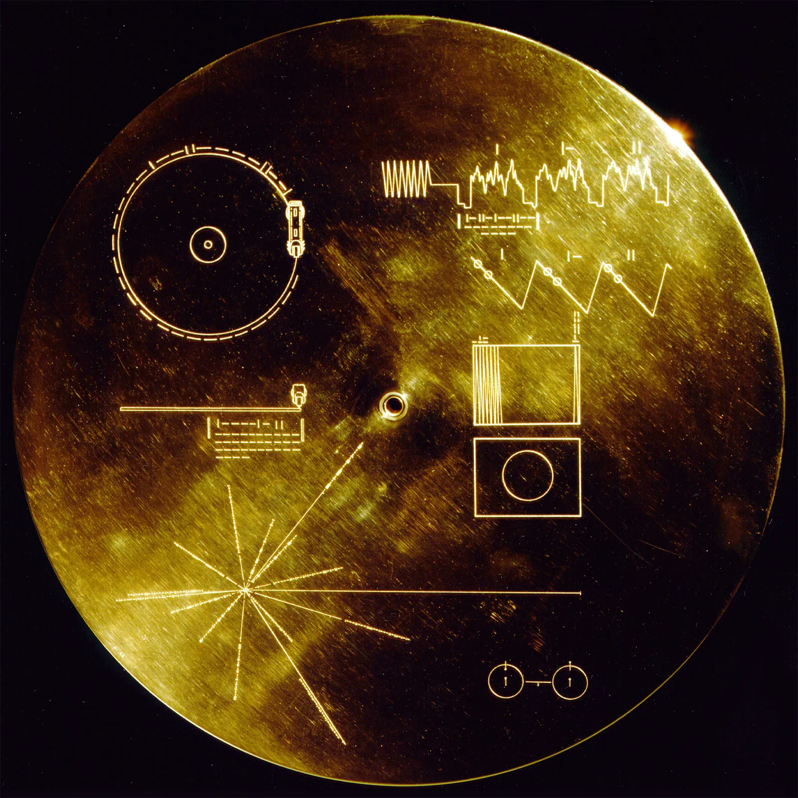 The Voyager Golden Record, an X-ray of a human hand etched among its contents, bound for interstellar space