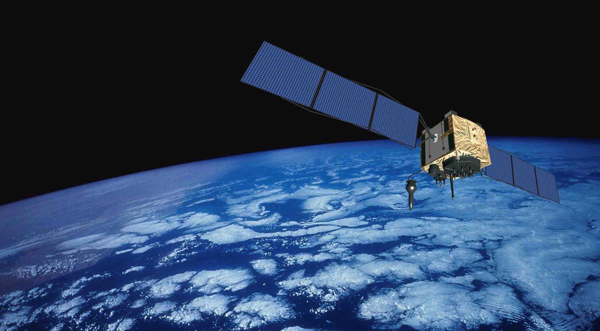 Two views of a GPS satellite: an artist's rendering in orbit above Earth with its solar panels deployed, and a real satellite wrapped in gold thermal insulation on a test range, its antenna array and panels extended, an engineer working beneath it.